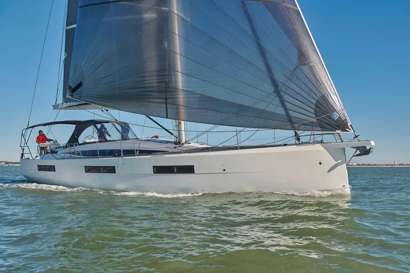 Slide: The Image of 2026 Jeanneau Yachts 60 sailing on open water under clear blue skies. - 2