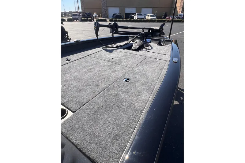 Slide: The Image of 2026 Tracker Pro Team 190 boat deck with carpeted surface and fishing equipment. - 7