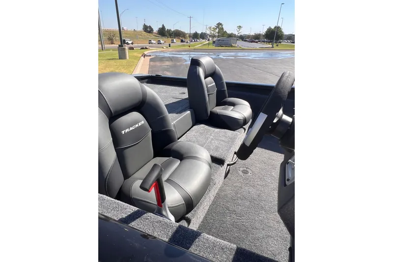 Slide: The Image of 2026 Tracker Pro Team 190 boat interior with black seats and steering wheel. - 8