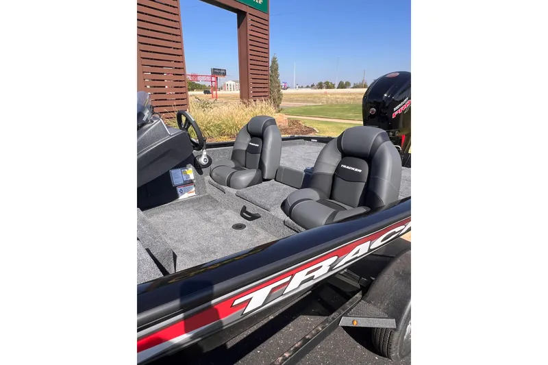 Slide: The Image of 2026 Tracker Pro Team 190 boat interior with two gray seats and steering wheel. - 9
