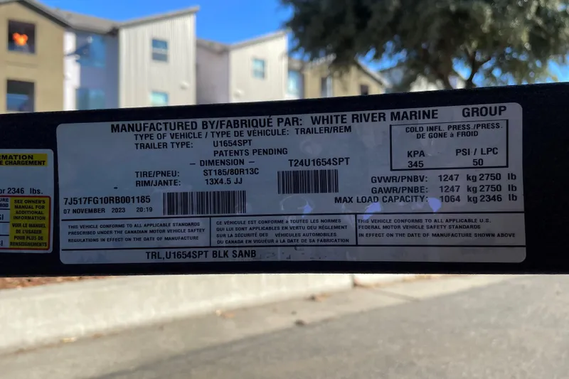 Slide: The Image of 2024 Tracker Grizzly 1654 T Sportsman trailer label with specifications and compliance details. - 45