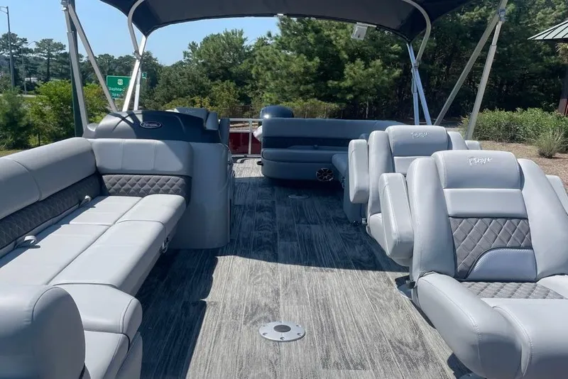 Slide: The Image of 2025 Ranger Reata 220FC pontoon boat with luxurious gray seating and canopy. - 1