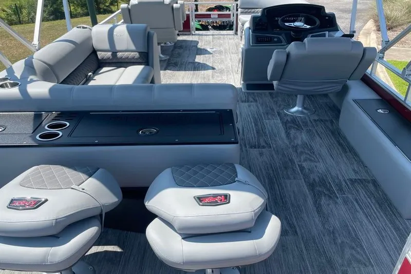 Slide: The Image of 2025 Ranger Reata 220FC boat interior with gray seating and modern dashboard. - 2