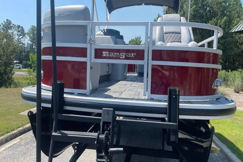 Slide: The Image of 2025 Ranger Reata 220FC pontoon boat on trailer, red and white exterior. - 3