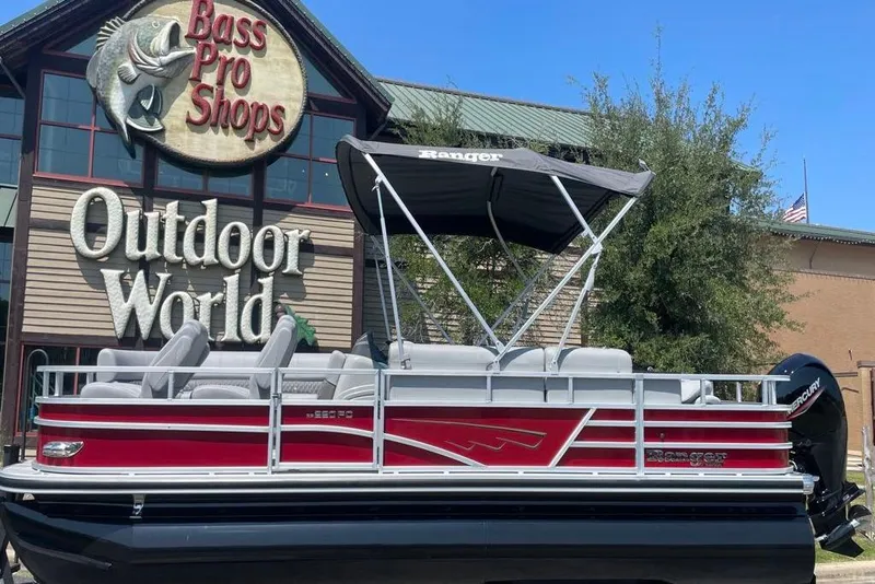 Slide: The Image of 2025 Ranger Reata 220FC pontoon boat displayed at Bass Pro Shops Outdoor World. - 5