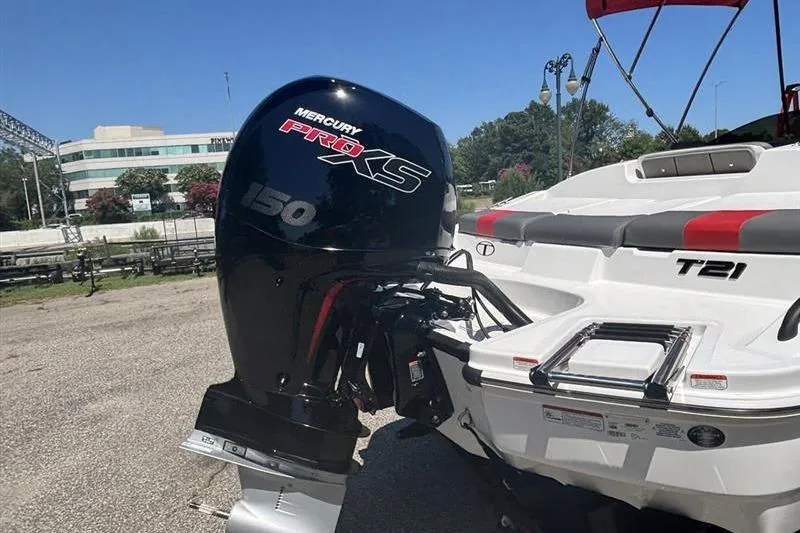 Slide: The Image of 2026 Tahoe T21 boat with Mercury Pro XS 150 engine, parked outdoors. - 4