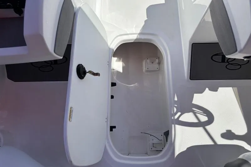 Slide: The Image of Open storage compartment in 2026 Tahoe T21 boat interior. - 10