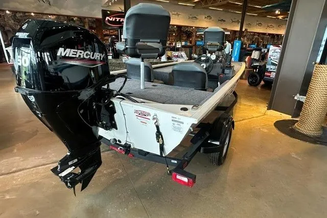 Slide: The Image of 2026 Tracker Pro 170 boat with Mercury engine displayed indoors. - 3
