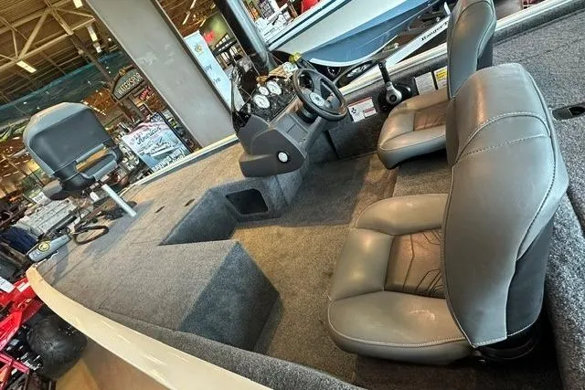 Slide: The Image of Interior of 2026 Tracker Pro 170 boat with gray seating and steering console. - 4