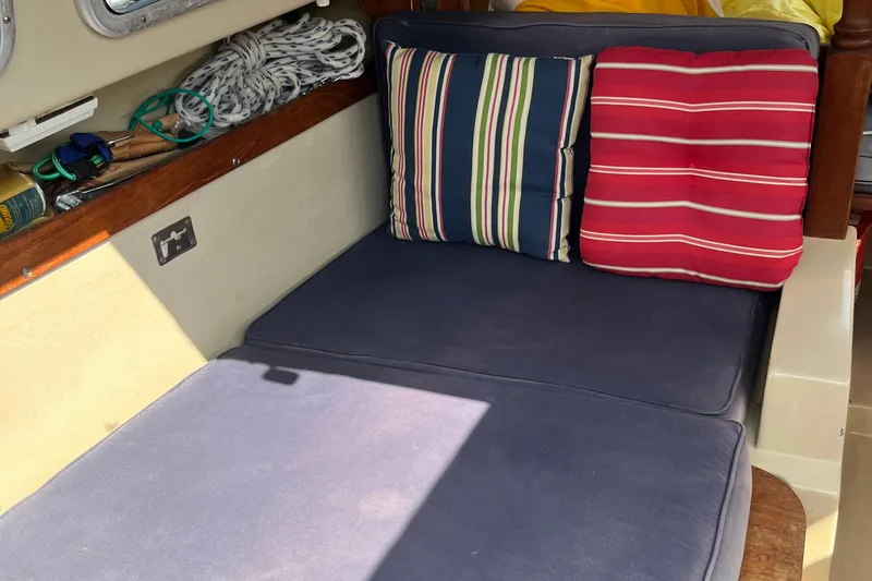 Slide: The Image of Interior of 1981 Catalina 22 sailboat with striped cushions and nautical accessories. - 10