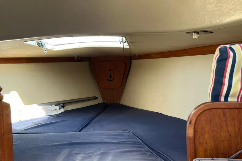Slide: The Image of Interior cabin of a 1981 Catalina 22 sailboat with striped cushions. - 14