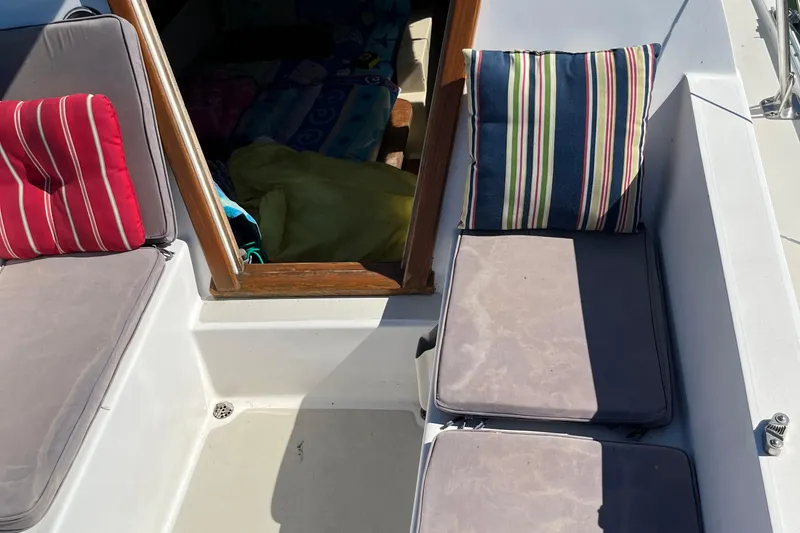 Slide: The Image of Interior view of a 1981 Catalina 22 sailboat with colorful cushions. - 9