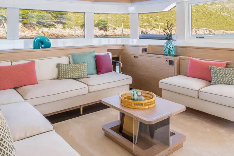 Slide: The Image of Luxurious interior of 2026 Lagoon 60 yacht with modern decor and colorful cushions. - 13