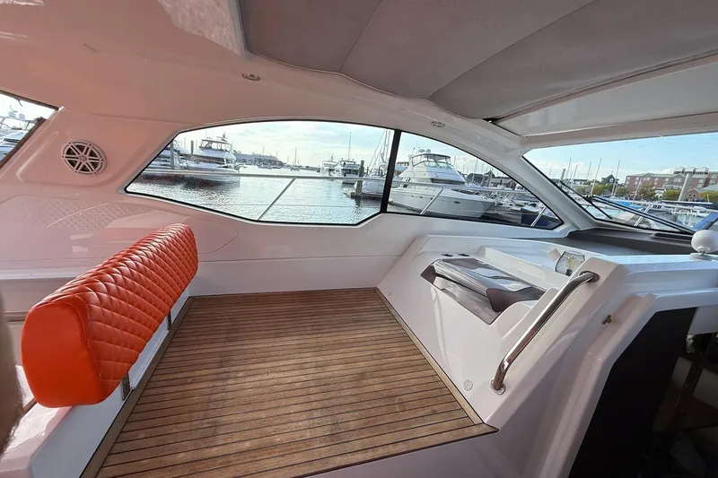 Slide: The Image of Interior of 2016 Azimut Atlantis 43 yacht with orange seating and marina view. - 20