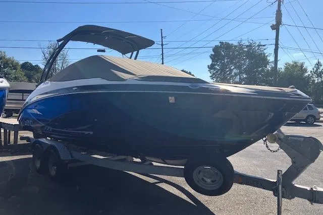 Slide: The Image of 2016 Yamaha AR240 boat on trailer, covered and parked outdoors. - 1
