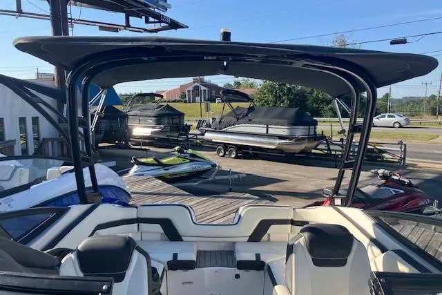 Slide: The Image of 2016 Yamaha Boats AR240 interior view with seating, docked near other boats. - 6