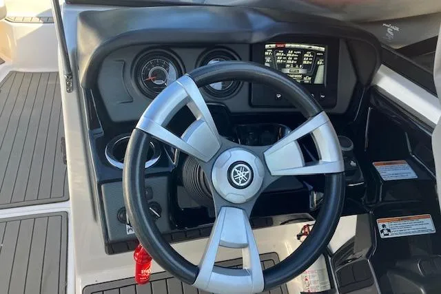 Slide: The Image of Steering wheel and dashboard of 2016 Yamaha AR240 boat, featuring gauges and controls. - 8