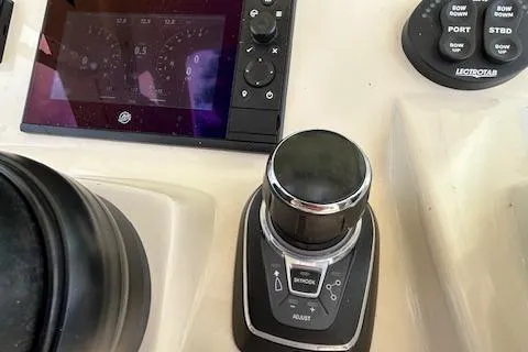 Slide: The Image of 2019 Scout 355 LXF boat control panel with joystick and display screen. - 35