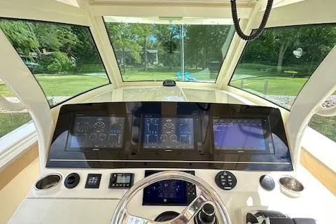 Slide: The Image of 2019 Scout 355 LXF boat dashboard with advanced navigation displays and controls. - 37