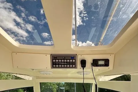 Slide: The Image of 2019 Scout 355 LXF boat interior with skylight and control panel. - 38