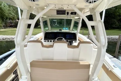 Slide: The Image of 2019 Scout 355 LXF boat interior with helm, seating, and navigation equipment. - 39