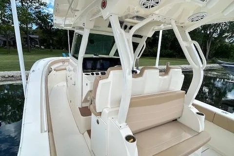 Slide: The Image of 2019 Scout 355 LXF boat interior with beige seating and modern dashboard. - 40