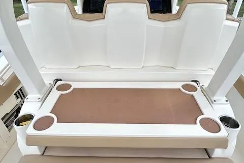 Slide: The Image of 2019 Scout 355 LXF boat seating area with integrated cup holders. - 43