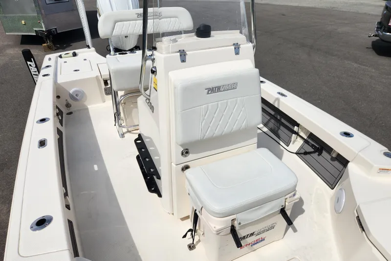 Slide: The Image of 2024 Pathfinder 2200 TRS boat interior with white seating and console. - 11