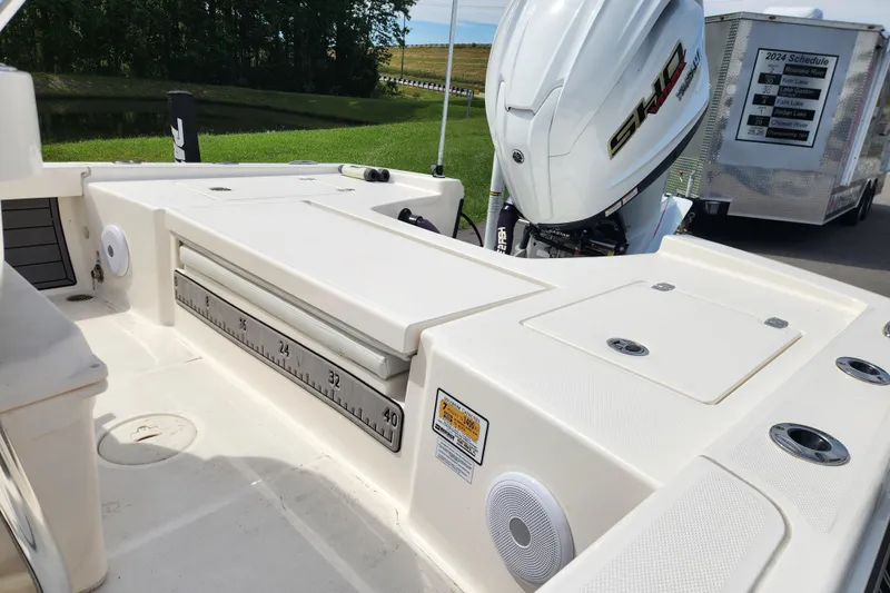 Slide: The Image of 2024 Pathfinder 2200 TRS boat with Yamaha engine, featuring spacious deck and measuring scale. - 16