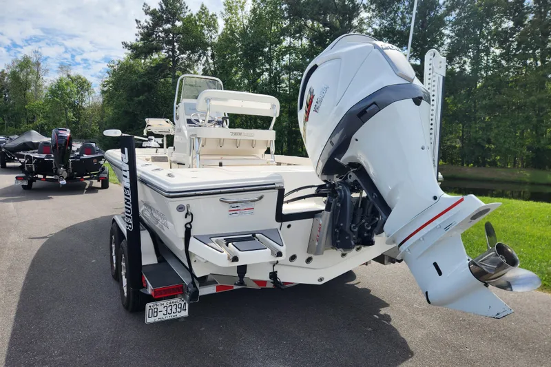 Slide: The Image of 2024 Pathfinder 2200 TRS boat with powerful outboard motor on trailer. - 3