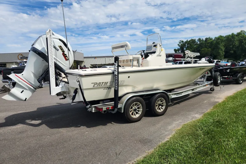 Slide: The Image of 2024 Pathfinder 2200 TRS boat on trailer, featuring Yamaha engine, parked outdoors. - 5