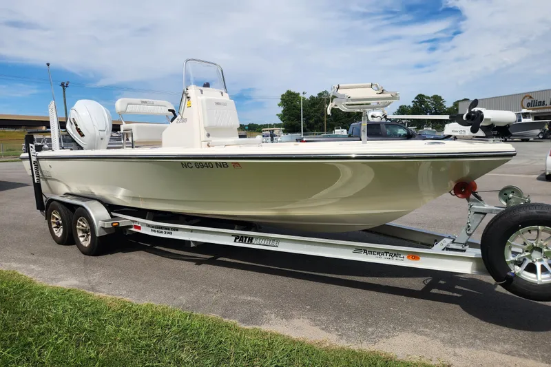 Slide: The Image of 2024 Pathfinder 2200 TRS boat on trailer, parked outdoors, showcasing sleek design and modern features. - 7
