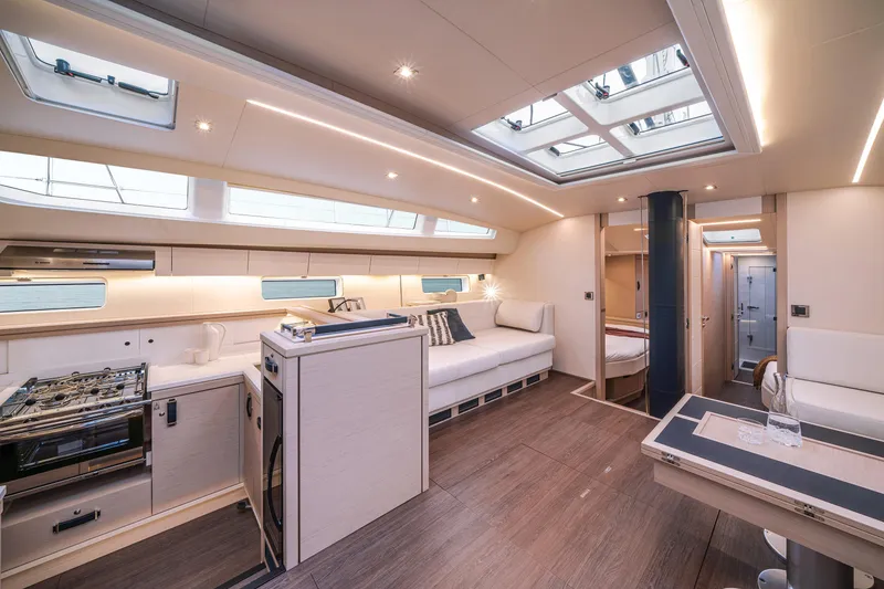 Slide: The Image of Luxurious interior of 2026 Jeanneau 65 yacht with modern kitchen and seating area. - 16