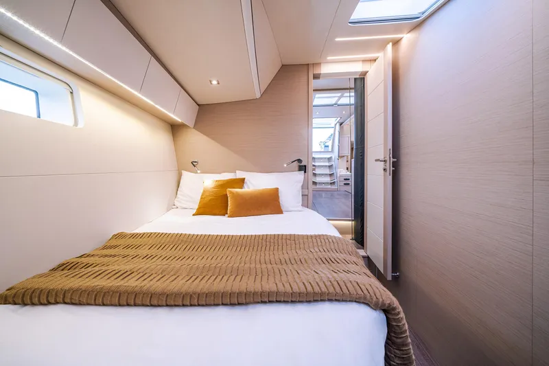 Slide: The Image of Luxurious cabin interior of 2026 Jeanneau 65 yacht with cozy bedding and modern design. - 18