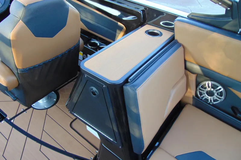 Slide: The Image of 2026 Yamaha Boats 255XD interior with tan and black seating, cup holder, and speaker. - 10