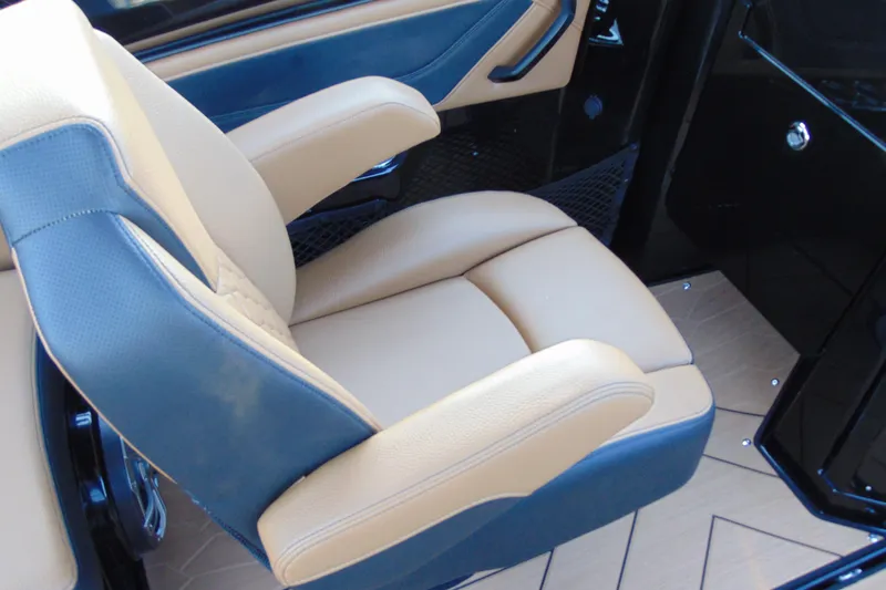 Slide: The Image of Luxurious seating in 2026 Yamaha Boats 255XD, featuring tan and blue upholstery. - 13