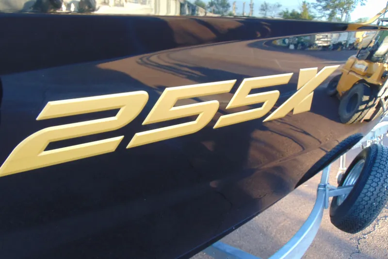 Slide: The Image of Close-up of 2026 Yamaha Boats 255XD model lettering on sleek black surface. - 6