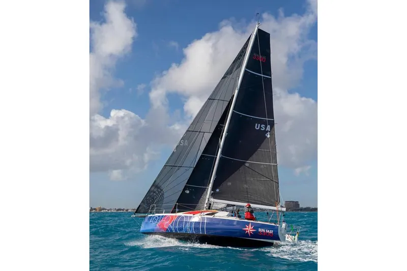 Slide: The Image of 2026 Jeanneau Sun Fast 3300 sailing on open water under clear skies. - 3