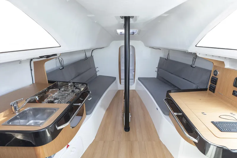 Slide: The Image of Interior of 2026 Jeanneau Sun Fast 3300 sailboat with modern kitchen and seating. - 8