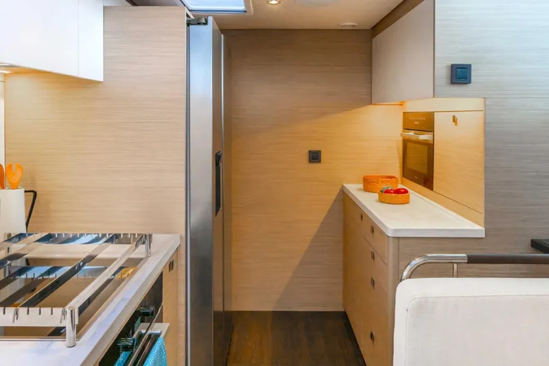 Slide: The Image of Modern kitchen interior of 2026 Lagoon 60 yacht with sleek appliances and wooden cabinetry. - 10