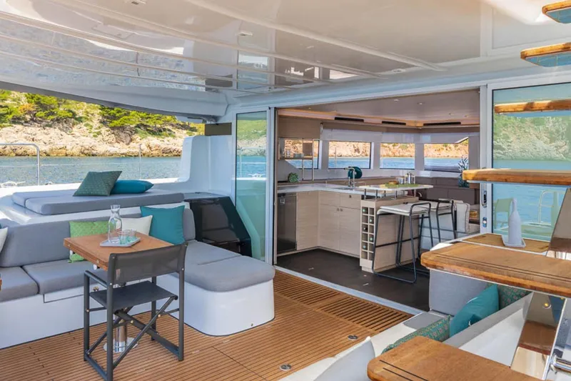 Slide: The Image of Luxurious Lagoon 60 yacht interior, 2026 model, featuring modern kitchen and seating area. - 15