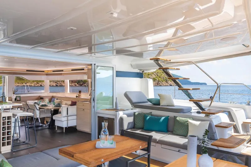 Slide: The Image of Luxurious 2026 Lagoon 60 yacht interior with elegant seating, dining area, and ocean view. - 16