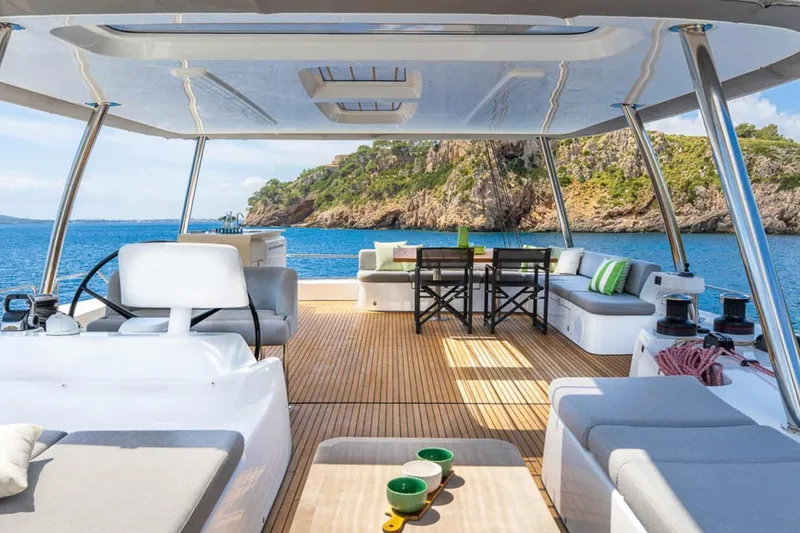 Slide: The Image of Luxurious 2026 Lagoon 60 yacht interior with ocean view, featuring elegant seating and dining area. - 20