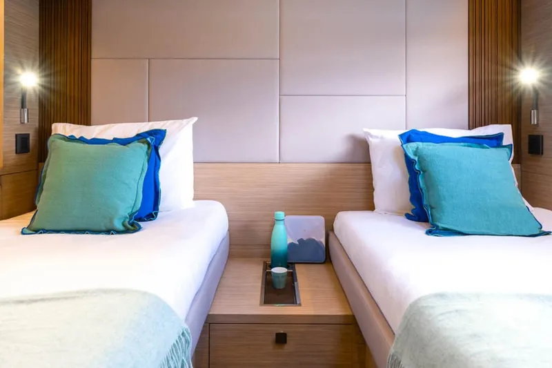 Slide: The Image of Luxurious twin cabin interior of 2026 Lagoon 60 yacht with modern decor and soft lighting. - 5