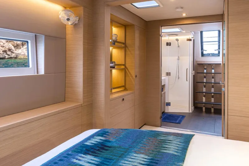 Slide: The Image of Luxurious interior of 2026 Lagoon 60 yacht with modern bathroom and cozy bedroom. - 6