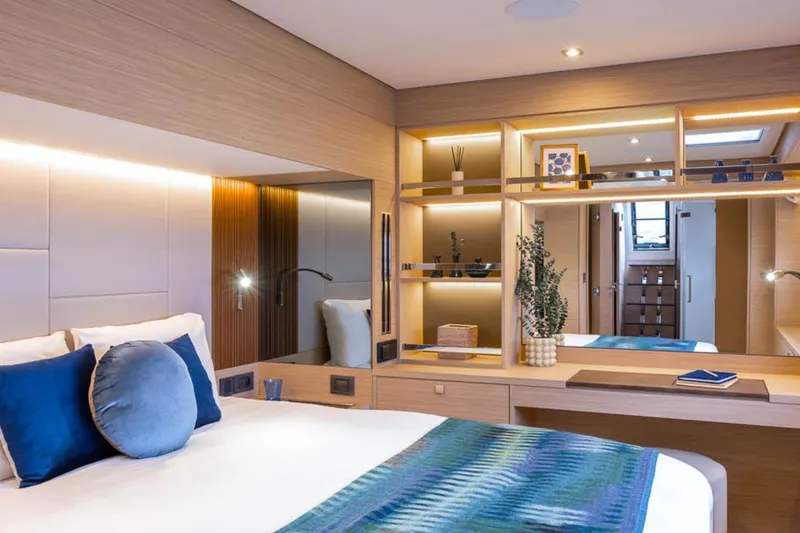 Slide: The Image of Luxurious 2026 Lagoon 60 yacht bedroom with modern decor and ambient lighting. - 7