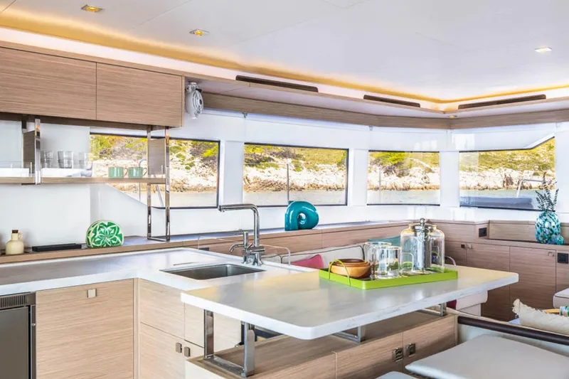 Slide: The Image of Luxurious interior of 2026 Lagoon 60 yacht with modern kitchen and scenic windows. - 8
