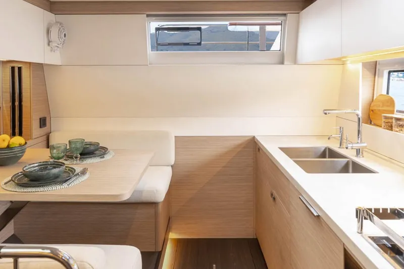 Slide: The Image of Modern kitchen interior of 2026 Lagoon 60 yacht with dining area and sleek design. - 9