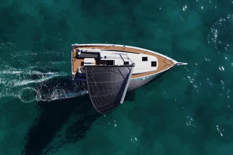 Slide: The Image of 2026 Jeanneau Sun Odyssey 380 sailing on clear turquoise waters, aerial view. - 2