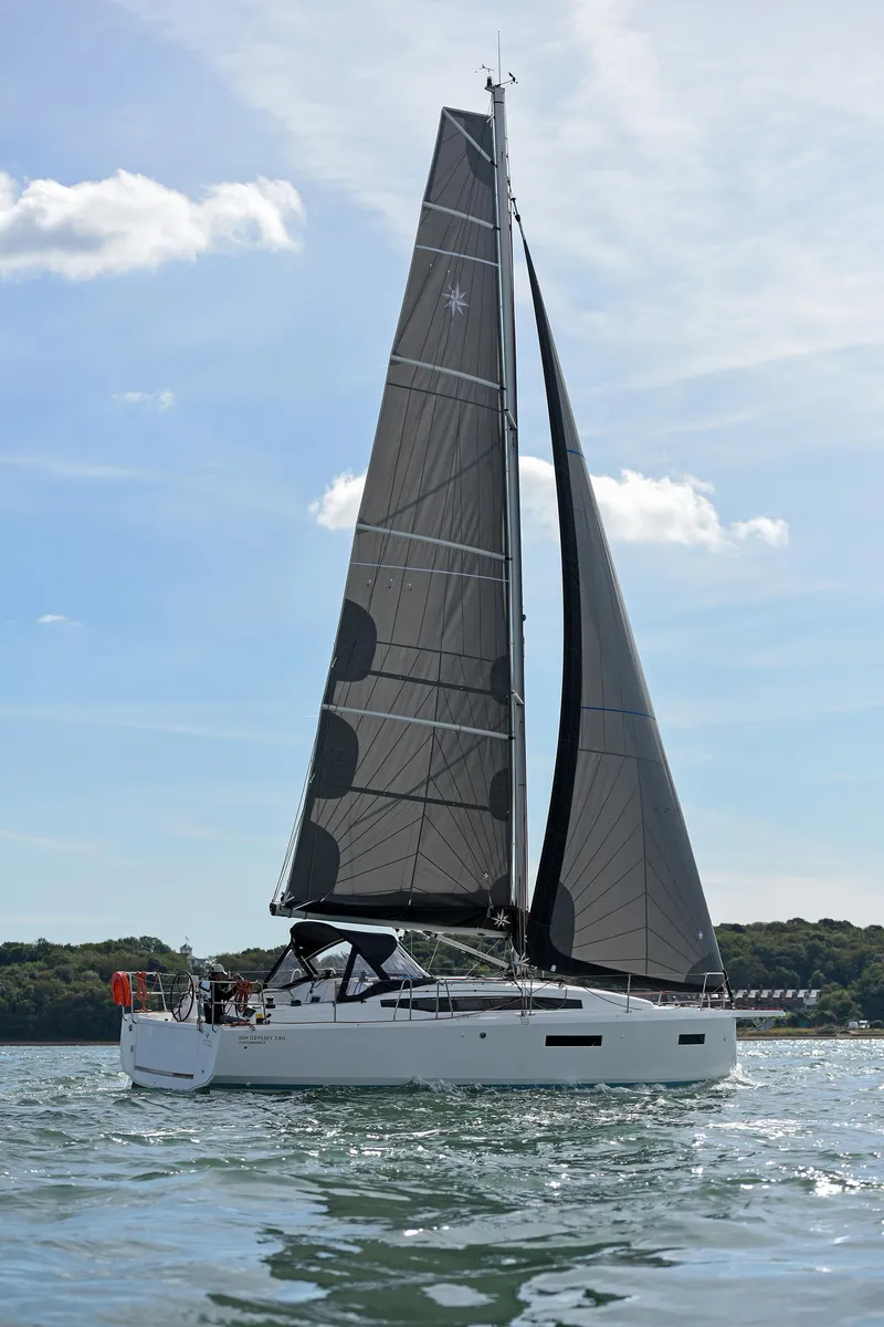 Slide: The Image of 2026 Jeanneau Sun Odyssey 380 sailing on calm waters under a clear sky. - 7